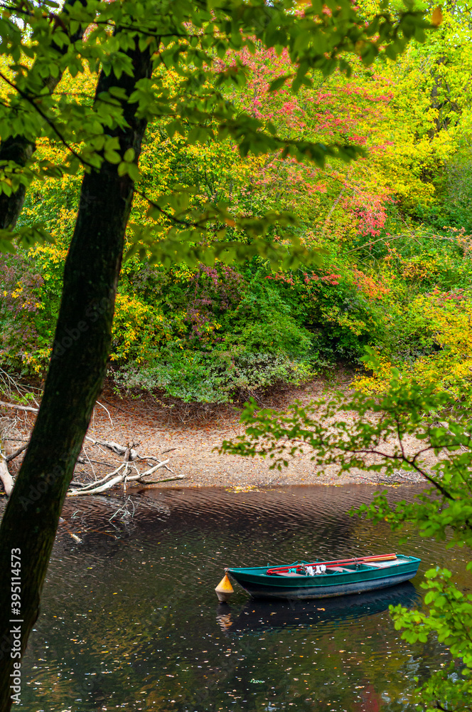 Mannheim, Germany. October 4th, 2009. Boat in the river in an autumn landscape in the Mannheim, Germany. October 4th, 2009. Boat in the river in an autumn landscape in the