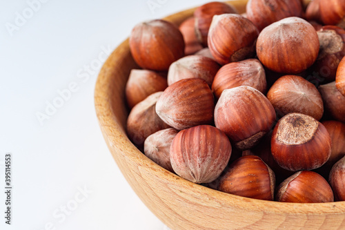 fresh natural hazelnuts on a white acrylic background