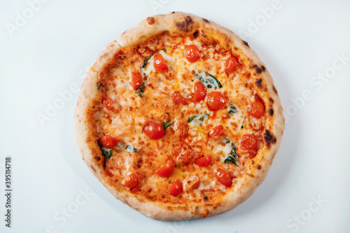 Italian pizza with tomatoes, spinach and cheese. Italian fast food delivery.