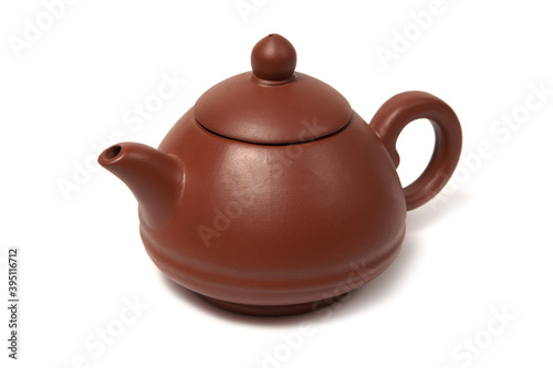 Old purple yixing clay Chinese teapot yuan zhu hu type for tea ceremony isolated on white photo