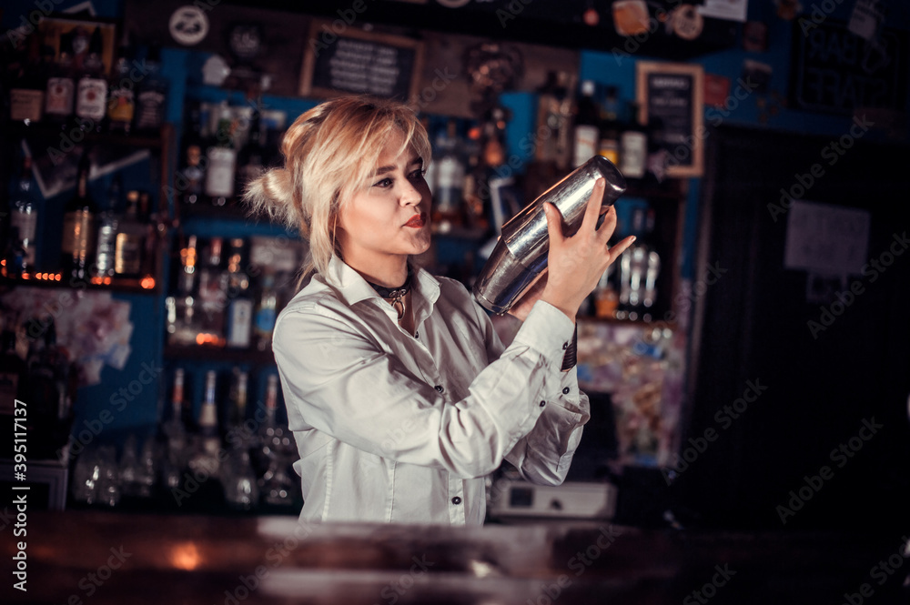 Girl bartender concocts a cocktail at the saloon