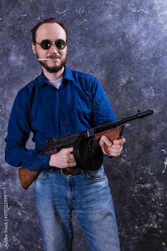 Mature man in sunglasses with tommy gun © idea_studio