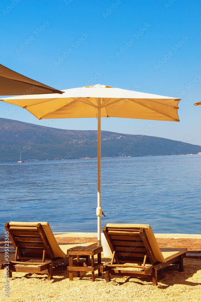 Summer beach vacations. Sunny day at the beach.  Montenegro, Adriatic Sea, view of Bay of Kotor near Tivat city