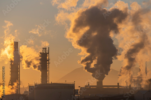 Factory smoke chimney piping smoke or steam into the air pollution