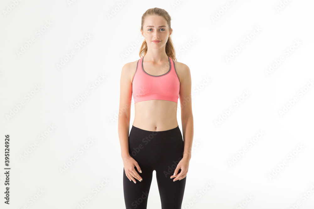 Sportive young girl standing on a light gray background. Sportive young girl standing on a light gray background.