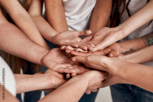 Diverse women holding their hands open palm on top of each other like a team. Concept of support, racial unity and relations in society