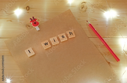 Wish list for Santa Claus and christmas decoration on wooden background