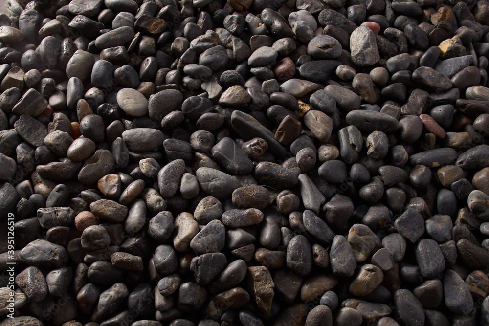 Black Pebbles close up macro detail round river bed drift rock flatlay background dark moody Black Pebbles close up macro detail round river bed drift rock flatlay background dark moody