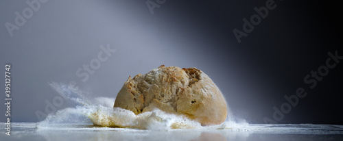 Craft bread splash over flour upon table