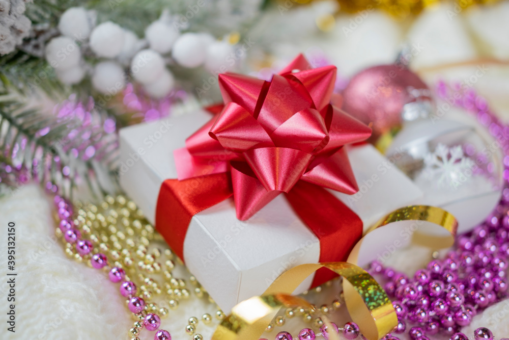 beautiful festive surprise gift box with a red bow on a bokeh background and near the Christmas tree for new year and valentine's day
beautiful festive surprise gift box with a red bow on a bokeh background and near the Christmas tree for new year and valentine's day