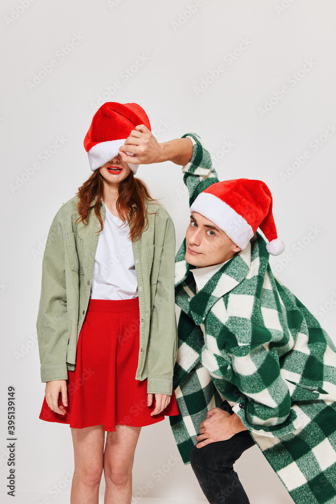 Obraz premium cheerful young couple hugs new year holiday friendship romance gifts 