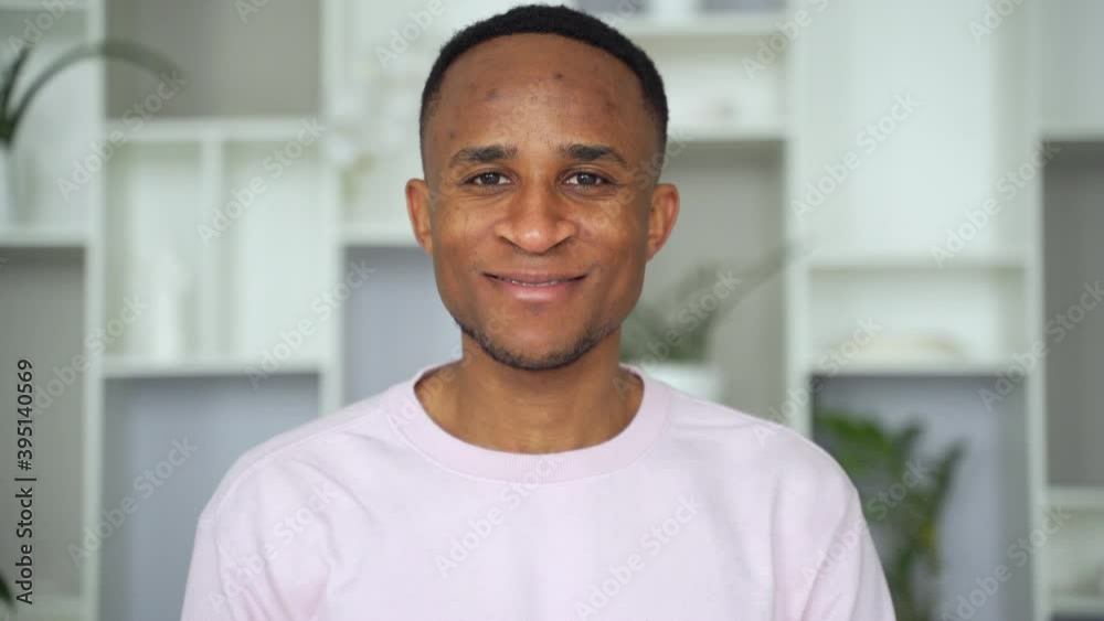 Confident smiling young african businessman looking at camera in office Confident smiling young african businessman looking at camera in office