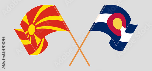 Crossed and waving flags of The State of Colorado and North Macedonia