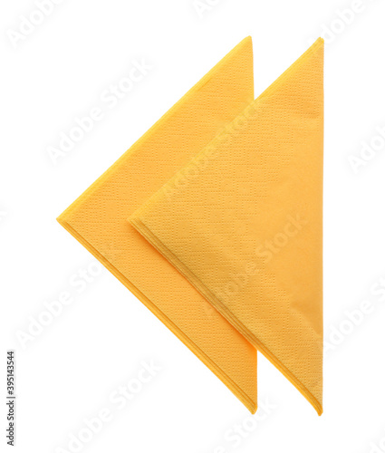 Folded yellow clean paper tissues on white background, top view