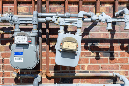 Gas meter with pipes on a brick wall photo