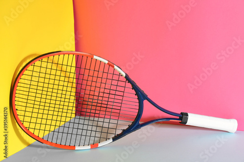 Tennis racket on color background. Sports equipment