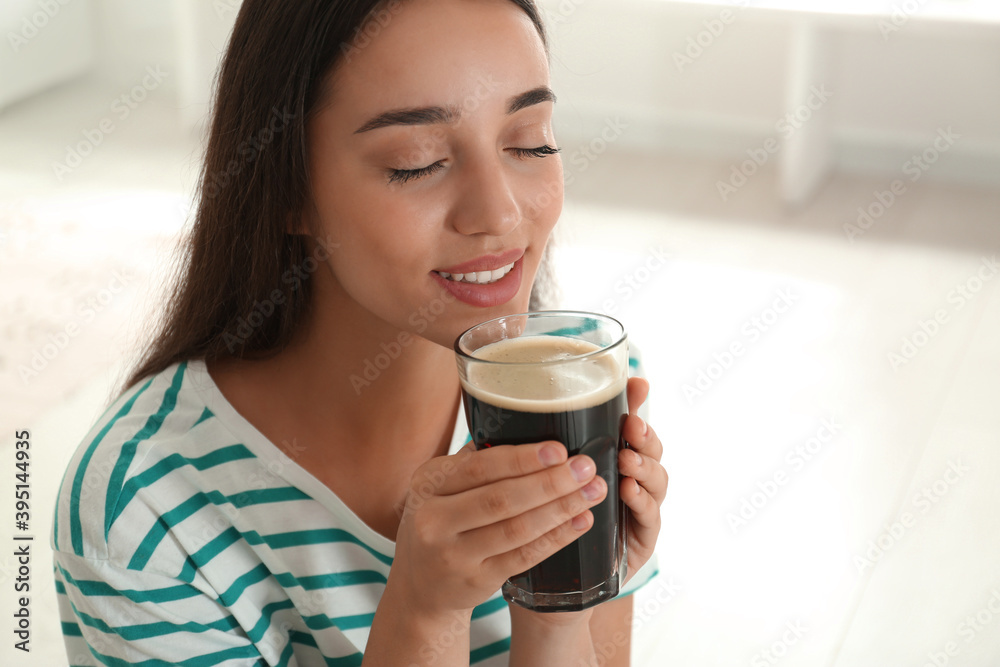 Beautiful woman with cold kvass indoors. Traditional Russian summer drink Beautiful woman with cold kvass indoors. Traditional Russian summer drink