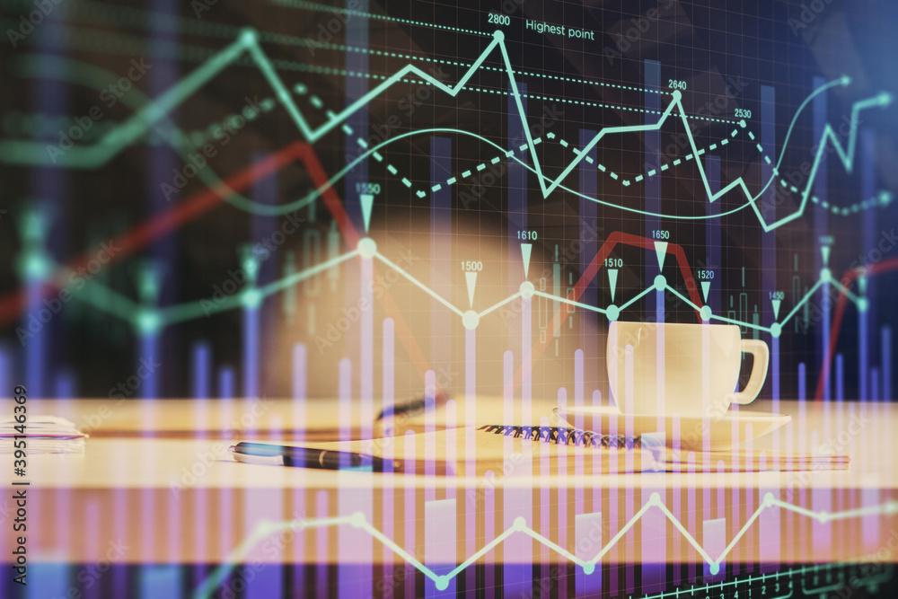 Multi exposure of forex graph drawing and desktop with coffee and items on table background. Concept of financial market trading Multi exposure of forex graph drawing and desktop with coffee and items on table background. Concept of financial market trading