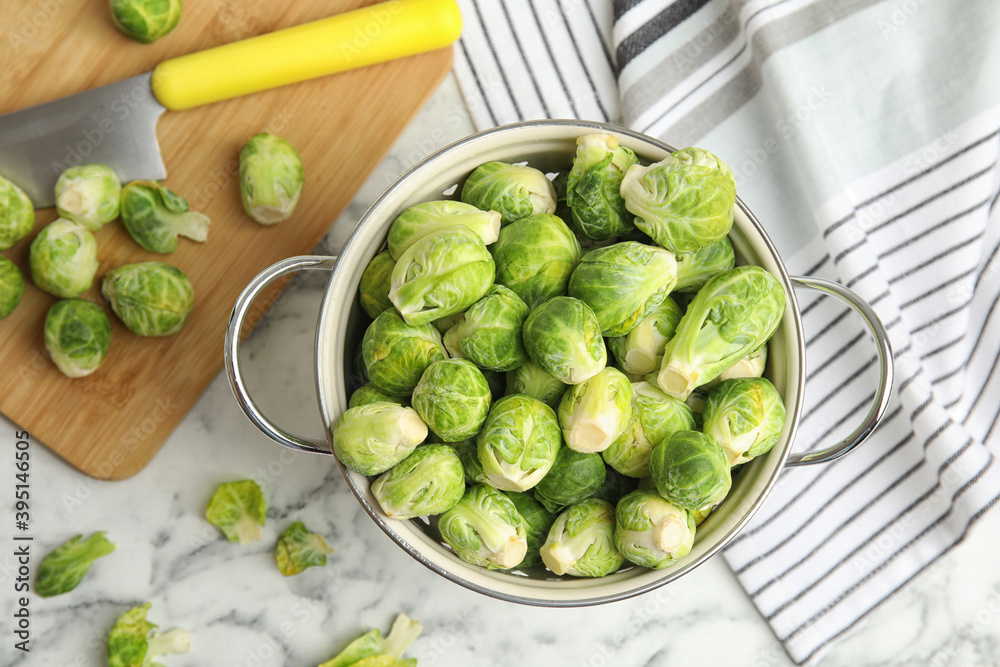 Fresh Brussels sprouts on white marble table, flat lay Fresh Brussels sprouts on white marble table, flat lay