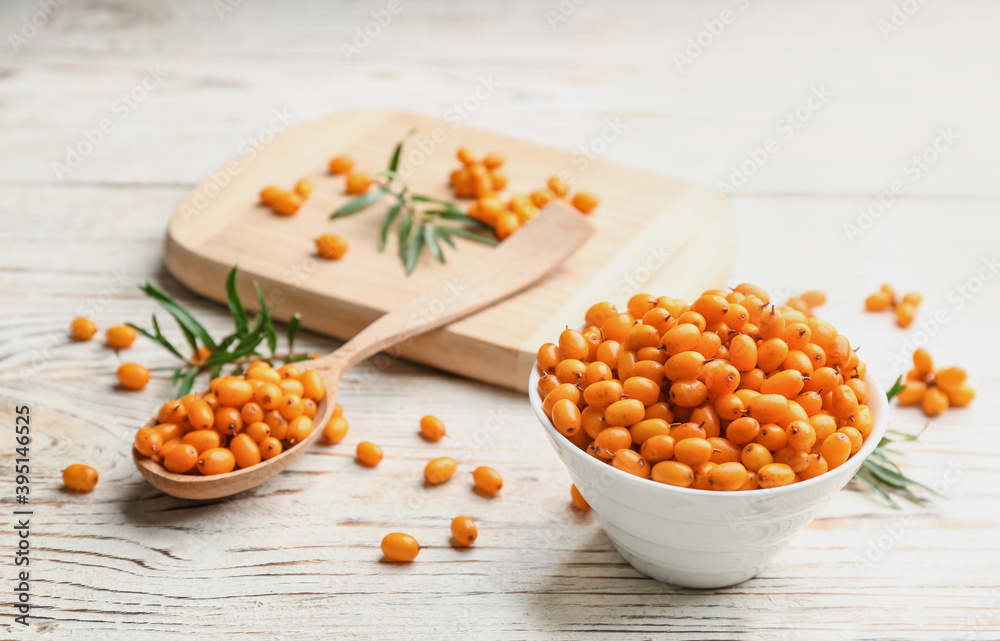 Fresh ripe sea buckthorn on white wooden table Fresh ripe sea buckthorn on white wooden table
