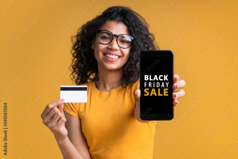 Attractive dark skinned girl with perfect smile showing mobile phone