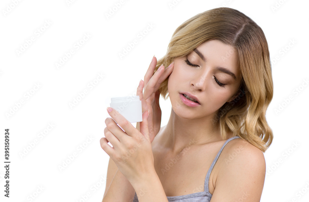 Young woman applying facial gel, peeling or mask on her face. Young woman applying facial gel, peeling or mask on her face.