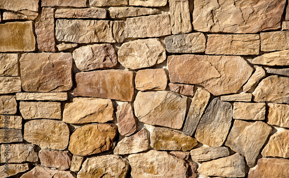 The wall is lined with large brown stones The wall is lined with large brown stones