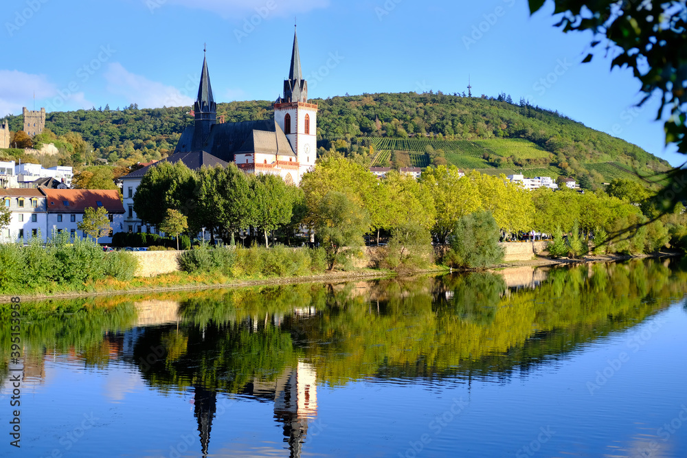 beautiful cityscape, a high church with a spire is reflected in the water of the river, lake, concept of ancient European architecture, tourism, travel