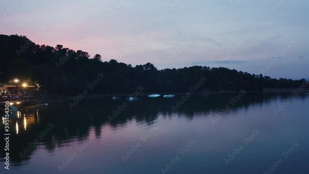 Aerial shot of a wake park in a lake during a beautiful sunset, glassy pond Aerial shot of a wake park in a lake during a beautiful sunset, glassy pond