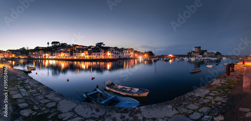 Look at Zokoa village's sea port with typical basque houses and the iconic frotress next to the ocean. photo