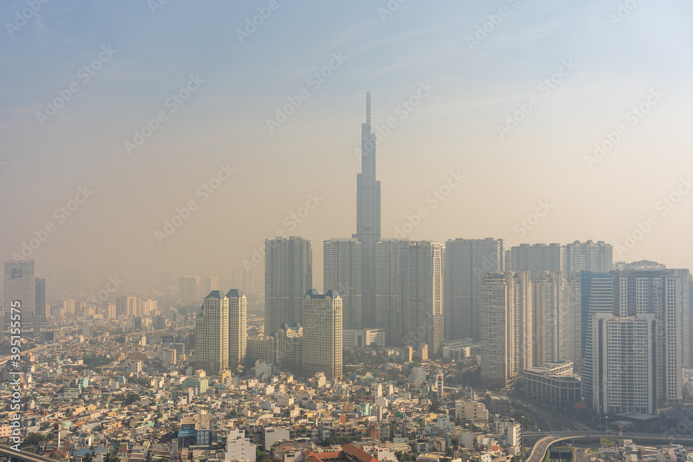 Air pollution of industrial city with hazy smog and skyscrapers