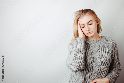 Worried, desperate woman suffering from headache