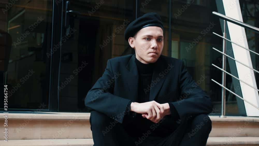 The worried caucasian man sitting on the stairs. The worried caucasian man sitting on the stairs.