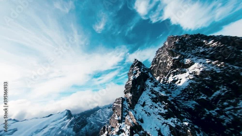 Aerial footage of mountain peaks covered in snow