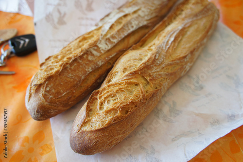 loaf of bread on wooden table, french baguette