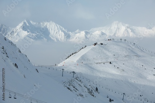 Skiing slopes in the French Alpes above the clouds, winter ski resort