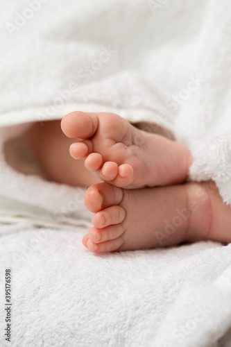 Macro Image of a Four Week Old Baby Boy Feet Over Heap of White Towes.