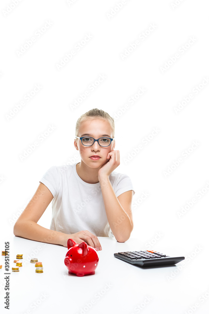 Portrait of Teenage Girl Posing With Coins and Moneybox. Calculating Income With Calculator. Portrait of Teenage Girl Posing With Coins and Moneybox. Calculating Income With Calculator.
