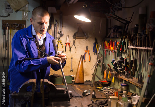 Routine work of gunsmith in a weapons workshop