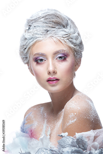 Winter Beauty Woman in clothes made of frozen flowers covered with frost, with snow on her face and shoulders. Christmas Girl Makeup. Make-up the snow Queen. Isolated on a white background.