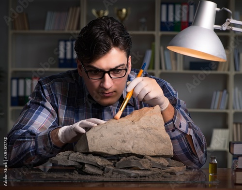 Archeologist working late night in office