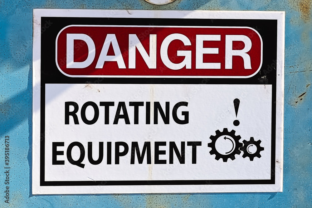 Closeup of a Danger Rotating Equipment sign Closeup of a Danger Rotating Equipment sign