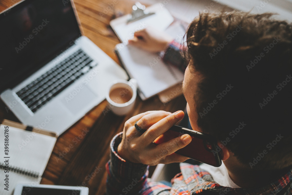 Fototapeta premium Man Working from Home on Laptop in Kitchen