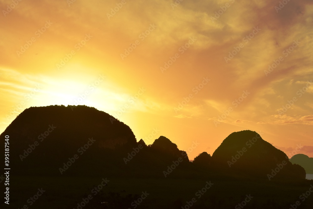 Beautiful scenery and sky with golden yellow white clouds and mountains before sunrise The sunrise from the top of the mountain Overlooking the sea and bay