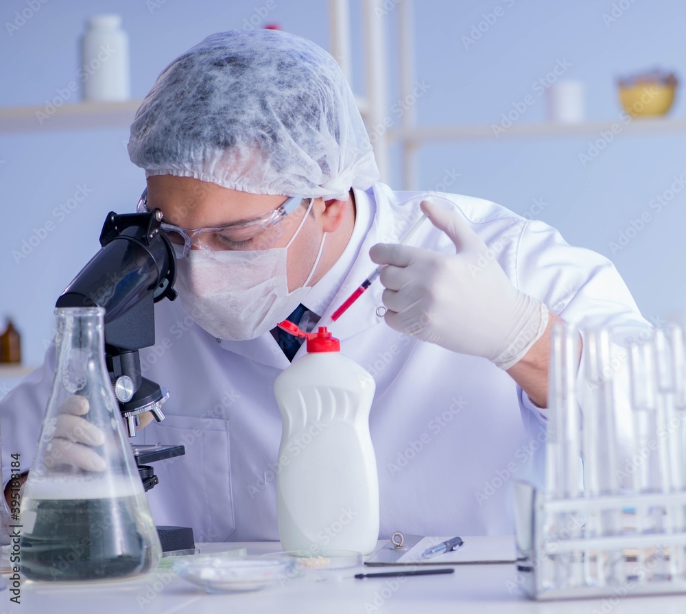 Man in the lab testing new cleaning solution detergent Man in the lab testing new cleaning solution detergent
