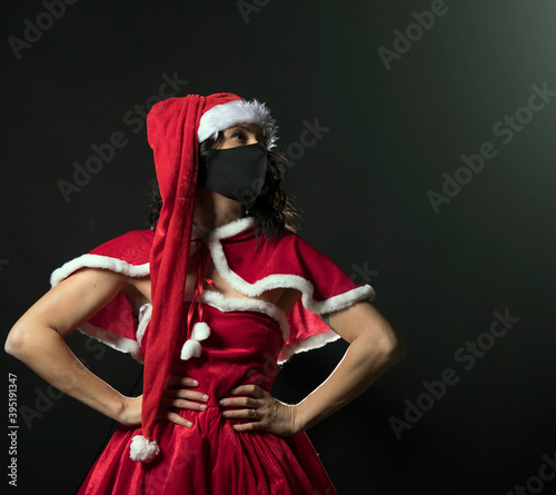 Beautiful female model wear santa hat. Christmas woman. Lifestyle. Happy day. 