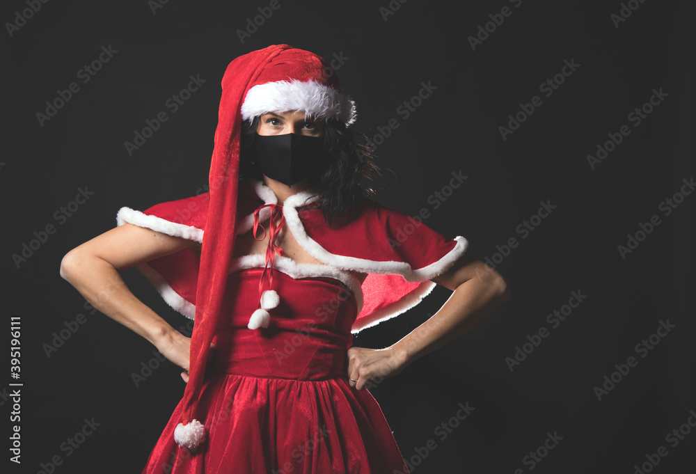 Beautiful female model wear santa hat. Christmas and New Year gifts. Mask. Celebration. Emotion. Model. Background. Santa hat. Beauty photo. Holidays. Portrait.
