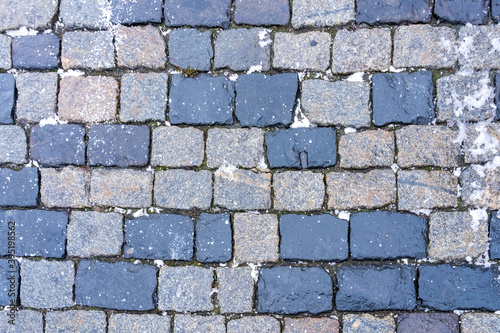 Paving stones on Red Square in Moscow from gabbro-diabases from the islands of Lake Onega in Karelia as a natural background