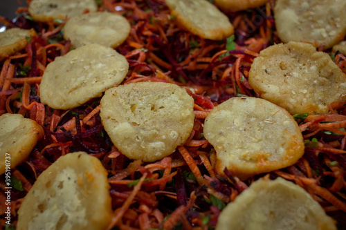 Close view of thattu vadai set (carrot and beetroot shredded and formed like burger) which is a popular south indian savoury. photo