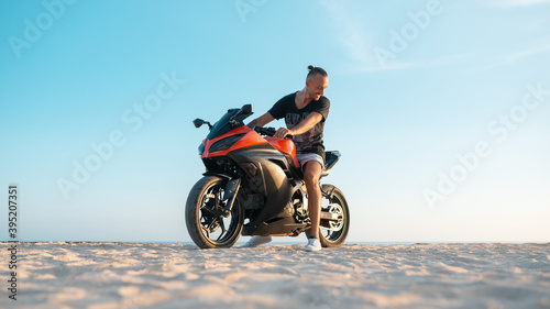 Young guy on a red sports motorcycle